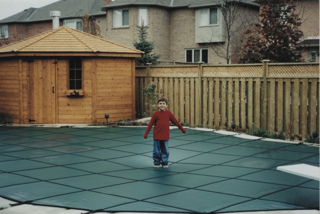 Boy on pool safety cover